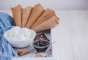 a tray of ice cream, jam and cups of powder on a wooden background