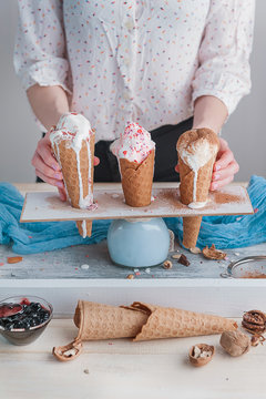 Three ice cream cones on a wooden background