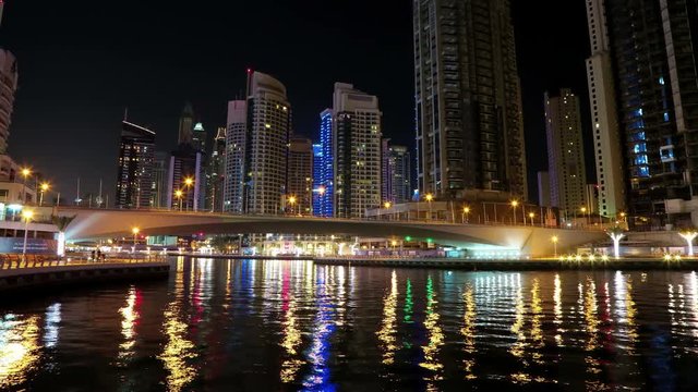 UHD 4K Dubai Marina night time lapse, United Arab Emirates. Dubai Marina - largest man-made marina in world. Dubai Marina is a canal city, carved along a 3 km stretch of Persian Gulf shoreline