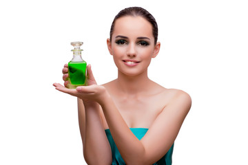 Fototapeta premium Woman holding a bottle of green perfume