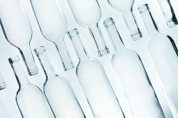Crystal glass empty bottles laying in two lines