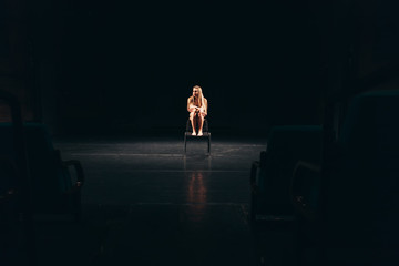 female actress alone on stage