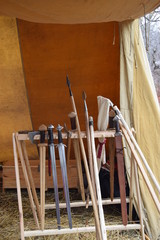 Viking weapons rack with axe swords and spears in a tent