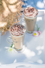 Delicious latte in summer on old wooden table