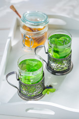 Mint tea with honey in white kitchen