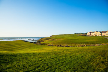 Half Moon Bay grass field and villa houses.  Golf course.