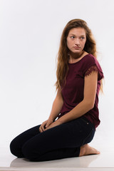 Fototapeta premium Young caucasian woman sits barefoot