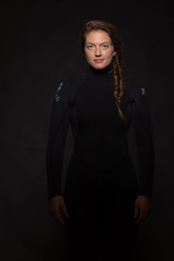 Young caucasian woman wearing a wetsuit standing confidently