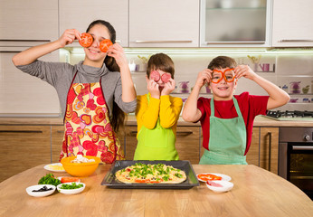 Three funny kids making the pizza