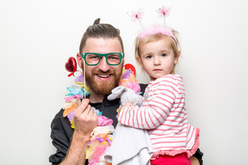 young man and baby happy smile posing on white background with party accessory props photo booth