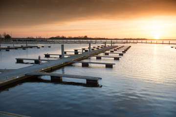 Obraz premium Yacht port over orange sunset