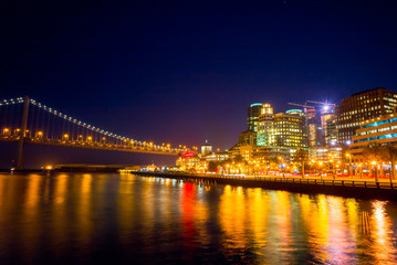 Fototapeta na wymiar Night view of San Francisco and the Bay Bridge. Cityscape from Pier 14. Night sky.