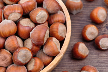 Bowl with hazelnuts on table