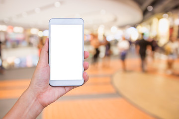 Woman's hand holding smart phone with blur supermarket backgroun