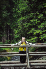 Woman walking over wooden bridge