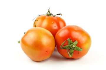 fresh tomatoes with green leaves isolated on white background