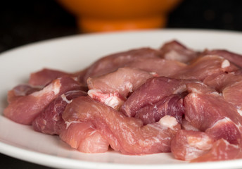 Fresh meat on a white plate, ready for grill or marinade