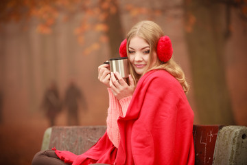 Girl with cup in park.