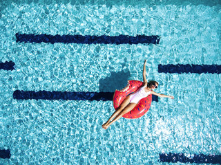 Woman relaxing with lilo in pool