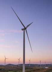 Fototapeta na wymiar Wind turbine power generator at twilight. 