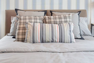 stylish bedroom interior design with striped pillows on bed