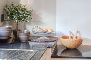 Ceramic kitchenware on the black granite counter top