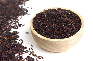 Close up of rice berry in wooden bowl on white background