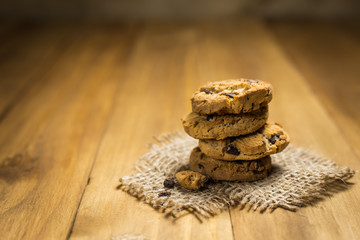 Chocolate cookies on a cloth sack on wood. Chocolate chip cookie