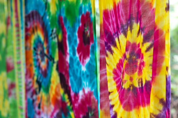 Fototapeta na wymiar Multi-colored Batik fabric. Tie dye fabric. dry clothes in the sun