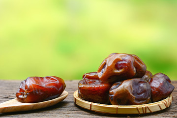 date palm on wooden table with nature background