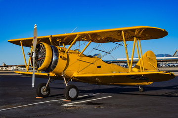 Yellow Biplane in an Airshow - obrazy, fototapety, plakaty