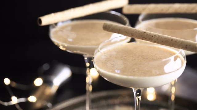 Egg nog cocktail in tall glasses on the tray at the minibar