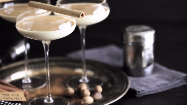 Egg nog cocktail in tall glasses on the tray at the minibar