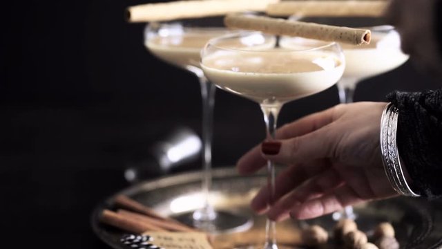 Egg nog cocktail in tall glasses on the tray at the minibar