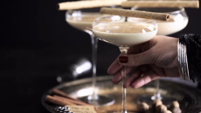 Egg nog cocktail in tall glasses on the tray at the minibar