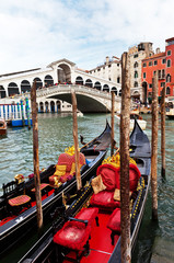 Venice. Quay Grand Canal near the Rialto Bridge. Two beautiful gondolas await tourists