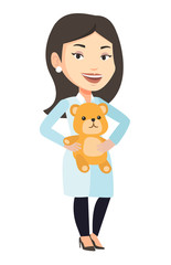Pediatrician doctor holding teddy bear.