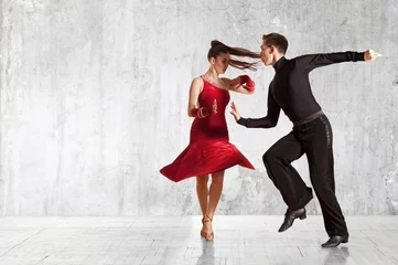 Fotobehang Beautiful couple in the active ballroom dance on wall © Andrey Burmakin