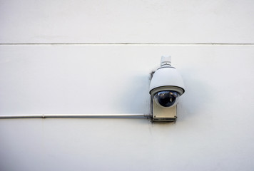 Security camera on concrete wall