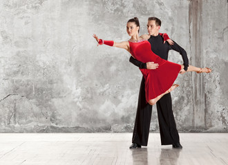 Beautiful couple in the active ballroom dance on wall