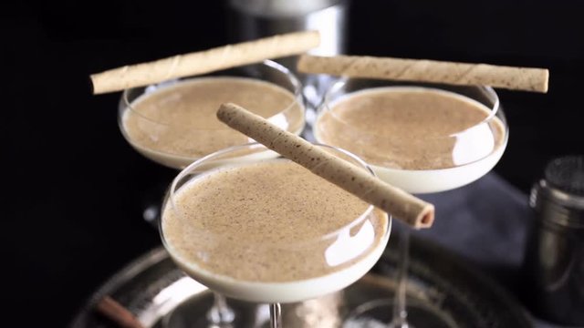 Egg nog cocktail in tall glasses on the tray at the minibar