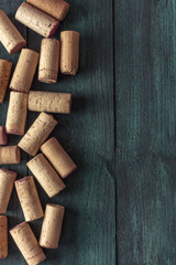Wine corks on dark wooden texture with copyspace