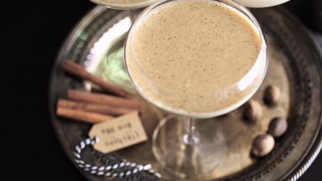 Egg nog cocktail in tall glasses on the tray at the minibar