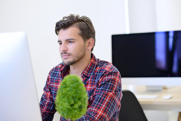 Rear View Of A Businessman in startup office Analyzing Graph On Computer
