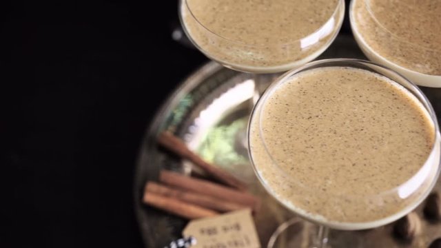Egg nog cocktail in tall glasses on the tray at the minibar