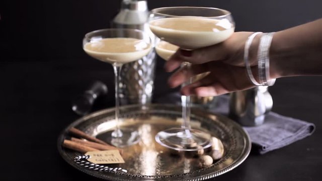 Egg nog cocktail in tall glasses on the tray at the minibar