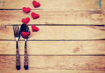 Table setting cutlery and red heart for dinner Valentine Day.