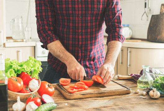 Man preparing delicious and healthy food in the home kitchen