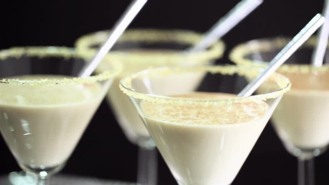 Egg nog cocktail in glasses rimmed with brown sugar at the minibar