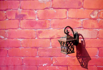 Fototapeta na wymiar Vintage lamp hanging on the brick wall with sweet pink tone